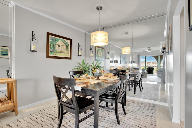 dining area with light tile patterned flooring, crown molding, and baseboards