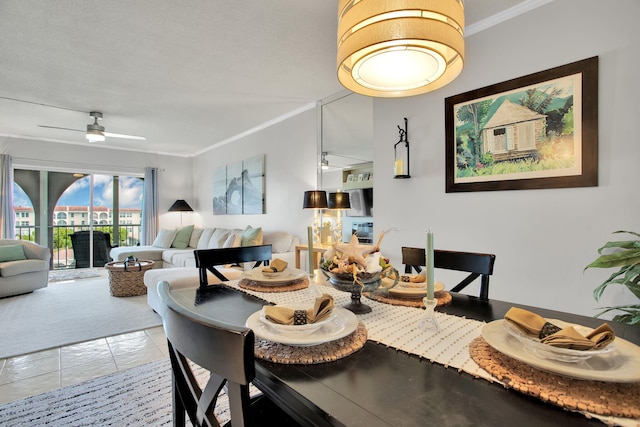 dining area with a ceiling fan, crown molding, and light tile patterned floors