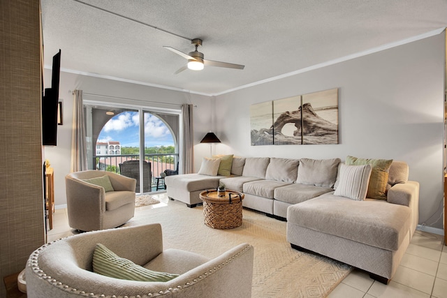 living room with ornamental molding, ceiling fan, a textured ceiling, and light tile patterned floors