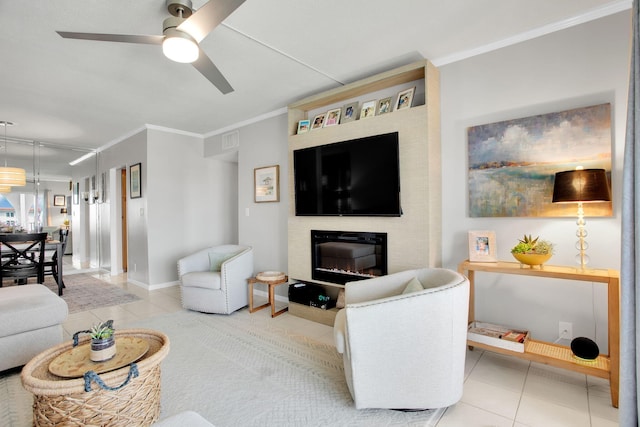 living area with crown molding, a glass covered fireplace, visible vents, and tile patterned floors