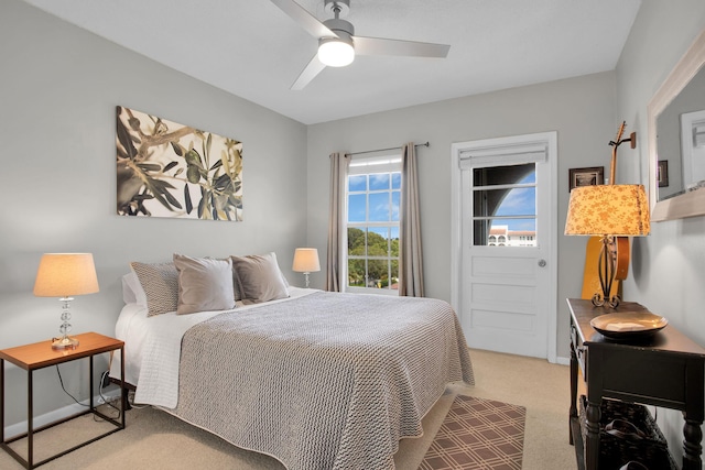 bedroom featuring light carpet and a ceiling fan