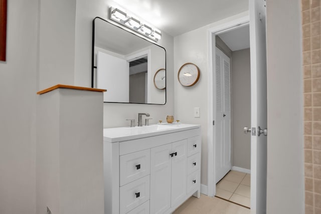 bathroom featuring tile patterned flooring, baseboards, and vanity