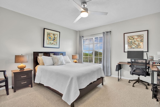 bedroom featuring light carpet, ceiling fan, baseboards, and a textured ceiling