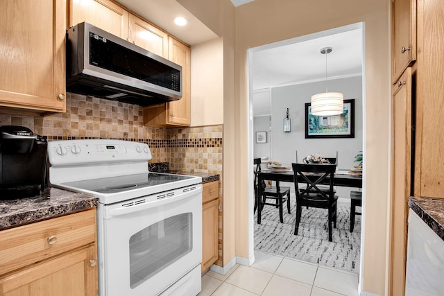 kitchen with stainless steel microwave, dark countertops, white electric range oven, and decorative backsplash