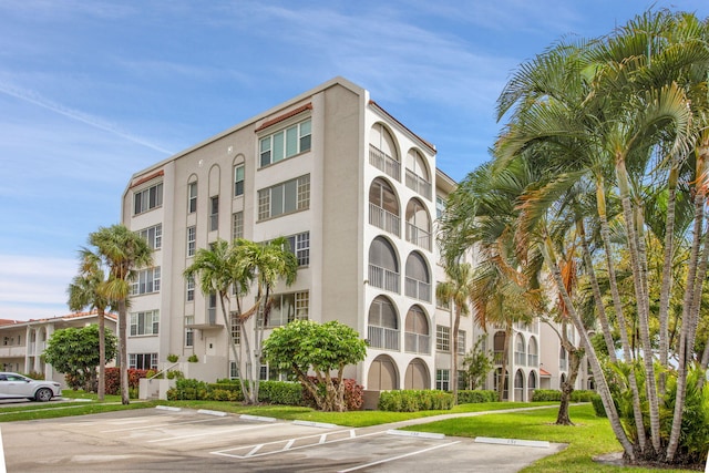 view of building exterior featuring uncovered parking