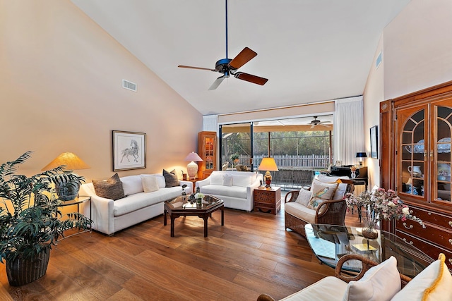 living room with high vaulted ceiling, ceiling fan, visible vents, and wood finished floors