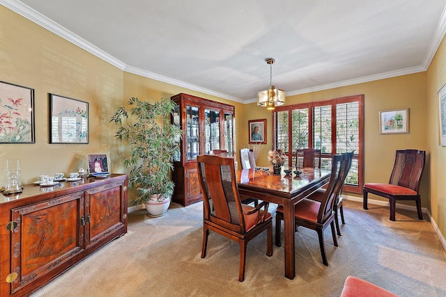 dining area with baseboards, ornamental molding, a notable chandelier, and light colored carpet