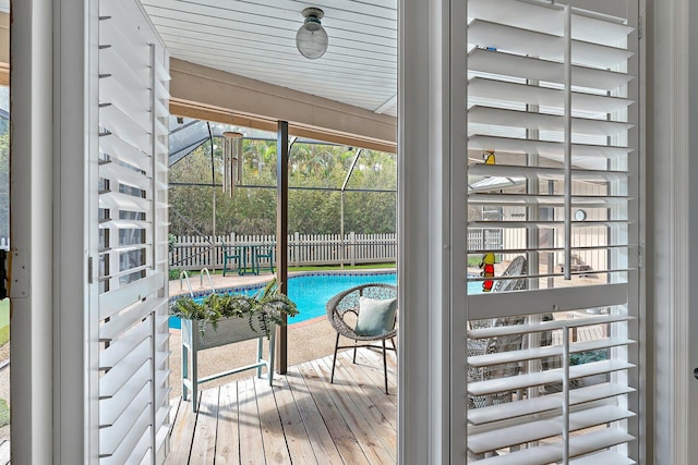 exterior space with a lanai, ceiling fan, and a fenced in pool