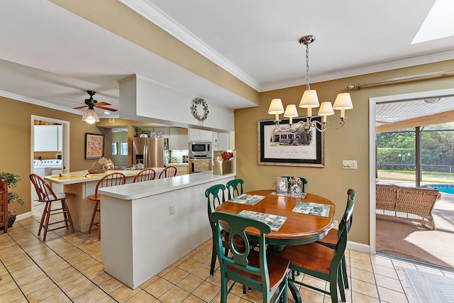 dining area with ornamental molding, ceiling fan with notable chandelier, baseboards, and light tile patterned floors