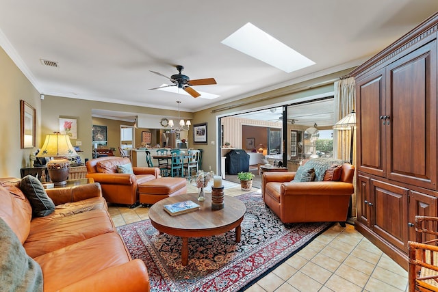 living area featuring a skylight, visible vents, crown molding, and light tile patterned floors