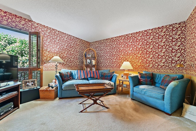 living room featuring carpet flooring, a textured ceiling, and wallpapered walls