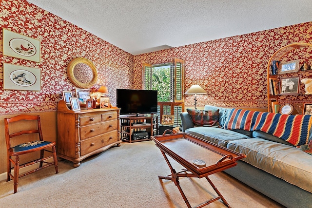 living room with wallpapered walls, a textured ceiling, and light colored carpet