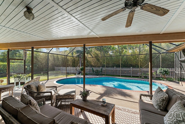 view of swimming pool featuring ceiling fan, a fenced backyard, an outdoor hangout area, a fenced in pool, and a patio area