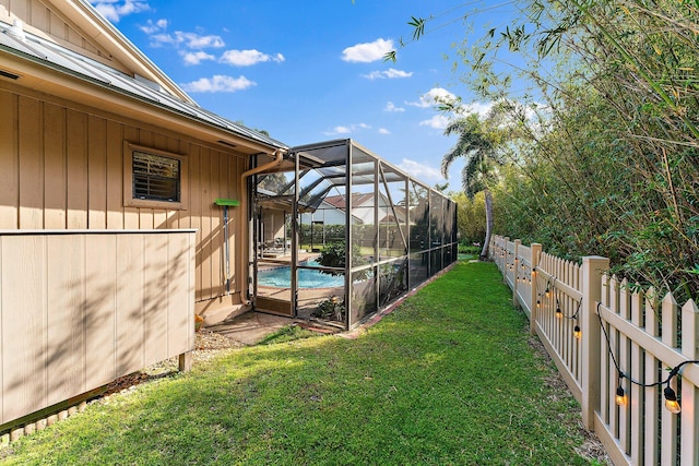 view of yard featuring a lanai, a fenced backyard, and a fenced in pool