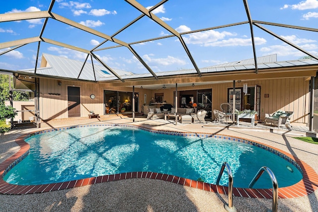 outdoor pool with a lanai, ceiling fan, and a patio