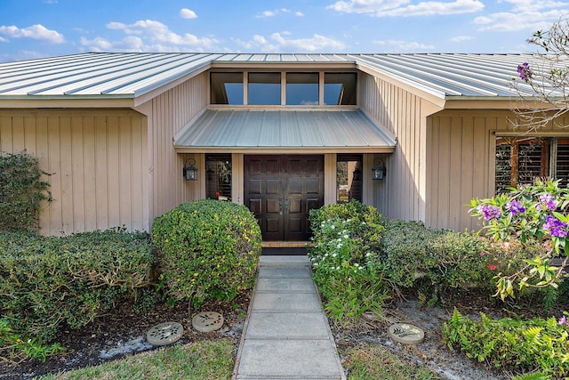 entrance to property featuring metal roof and a standing seam roof