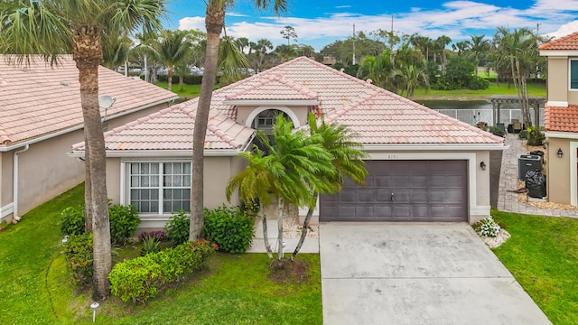 mediterranean / spanish-style home featuring an attached garage, driveway, a tiled roof, and stucco siding