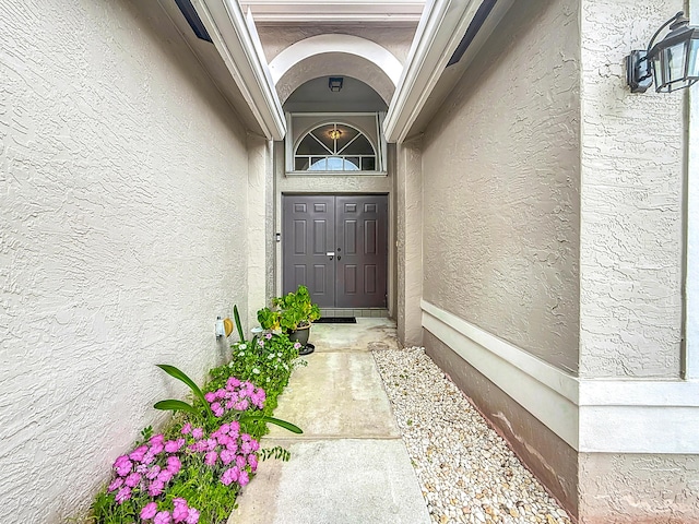 entrance to property with stucco siding