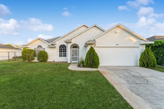 single story home featuring an attached garage, a front lawn, concrete driveway, and stucco siding