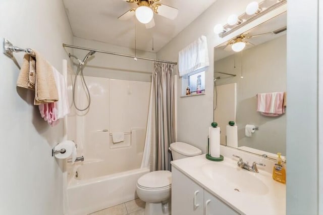 bathroom featuring tile patterned flooring, toilet, vanity, a ceiling fan, and shower / bath combo with shower curtain