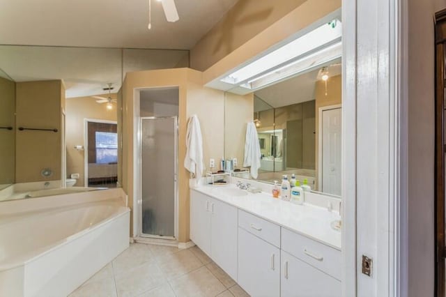 bathroom with tile patterned floors, ceiling fan, and a shower stall