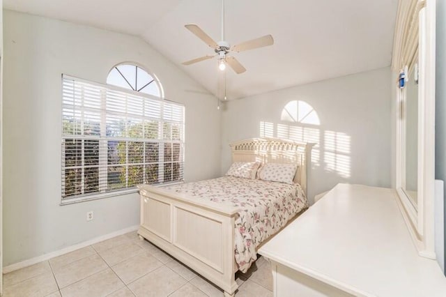 bedroom featuring vaulted ceiling, ceiling fan, light tile patterned floors, and baseboards