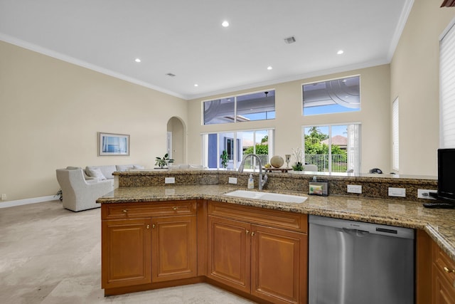 kitchen featuring brown cabinetry, dishwasher, light stone countertops, crown molding, and a sink