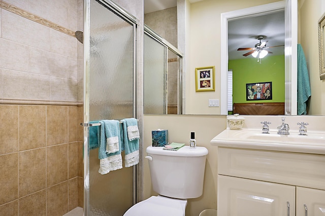 full bath featuring ceiling fan, toilet, a shower stall, and vanity