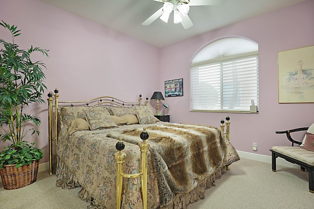 bedroom with ceiling fan, baseboards, and light colored carpet