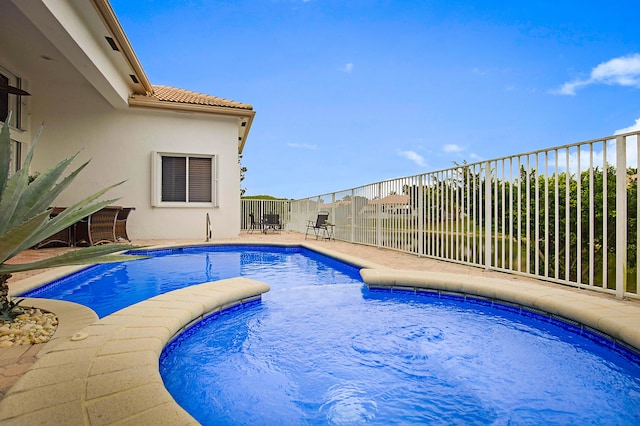 view of pool with a patio, fence, and a fenced in pool