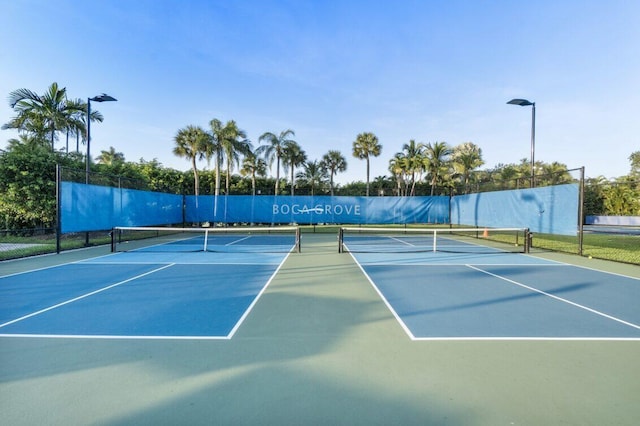 view of tennis court featuring fence