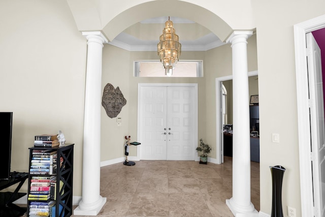 entryway with light tile patterned flooring, decorative columns, and baseboards