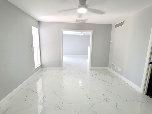 spare room featuring visible vents and baseboards