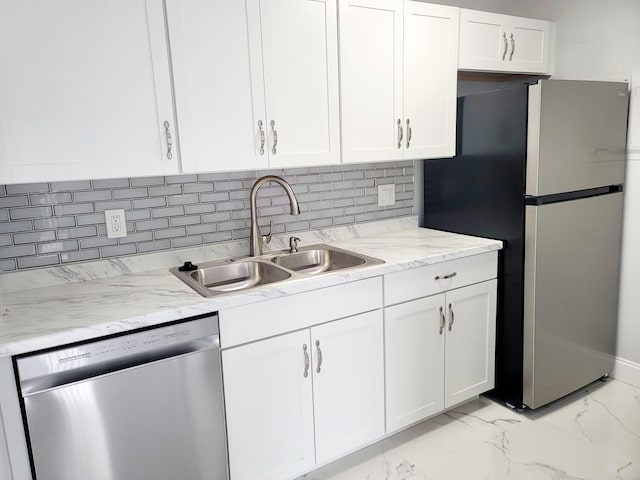 kitchen featuring marble finish floor, appliances with stainless steel finishes, white cabinets, and a sink