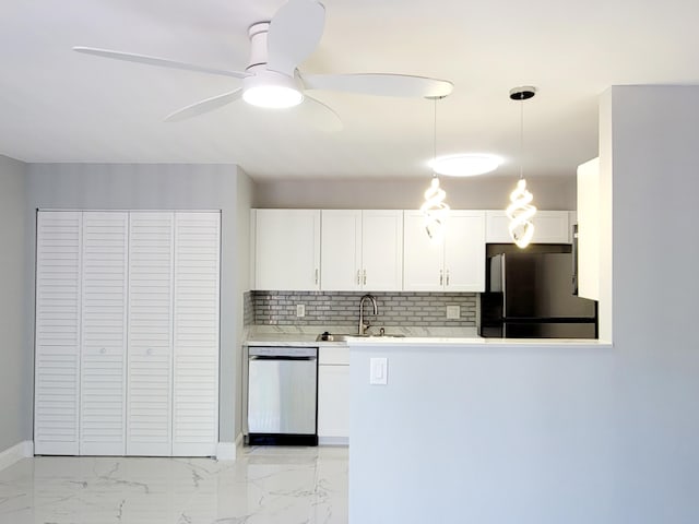 kitchen featuring white cabinets, dishwasher, freestanding refrigerator, light countertops, and a sink