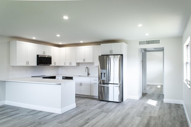 kitchen featuring a sink, white cabinetry, visible vents, light countertops, and stainless steel fridge with ice dispenser