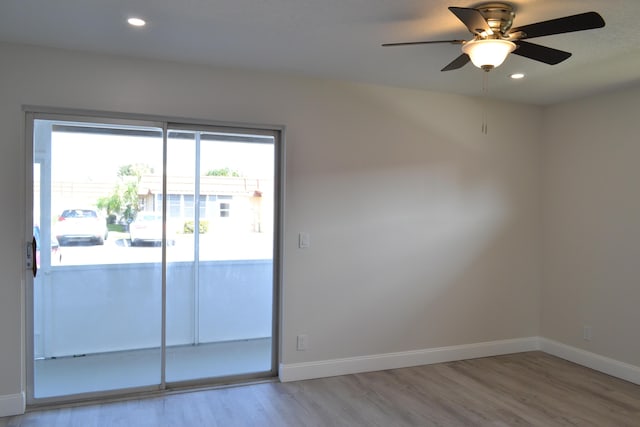 unfurnished room featuring recessed lighting, wood finished floors, and baseboards