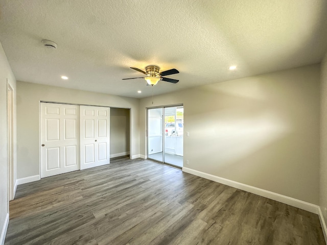 unfurnished bedroom with access to outside, dark wood-type flooring, and baseboards