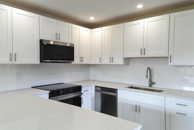 kitchen with electric stove, stainless steel microwave, white cabinetry, a sink, and dishwashing machine