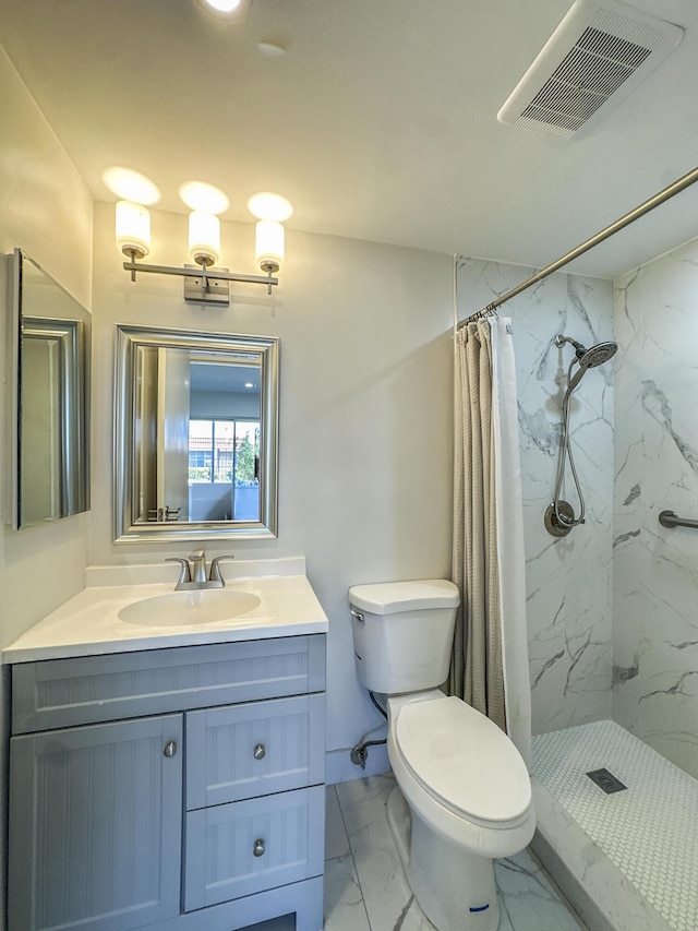 bathroom featuring marble finish floor, a marble finish shower, visible vents, and vanity