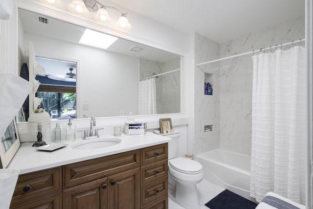 full bathroom featuring toilet, a skylight, vanity, visible vents, and shower / bath combo with shower curtain