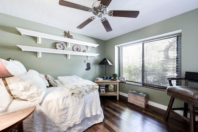 bedroom featuring ceiling fan, baseboards, and wood finished floors