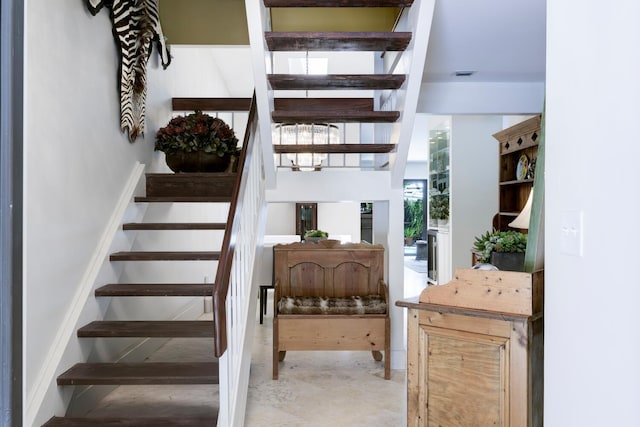 stairs with concrete flooring and visible vents