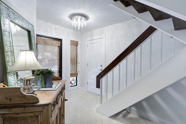 foyer with an inviting chandelier and stairs