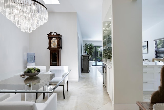 dining room with a skylight and a notable chandelier