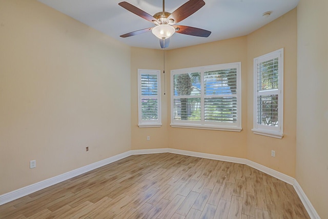 unfurnished room with baseboards, ceiling fan, and light wood finished floors