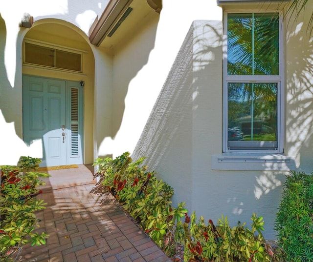 doorway to property with stucco siding