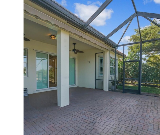 view of patio / terrace featuring a lanai and a ceiling fan