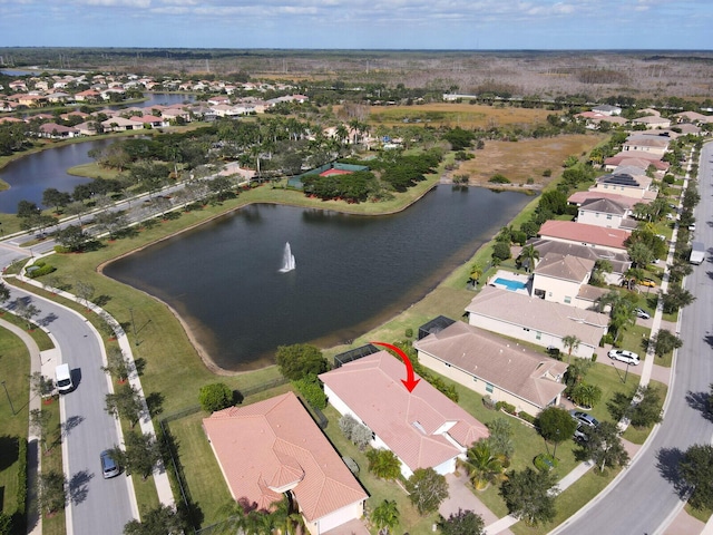 drone / aerial view with a water view and a residential view