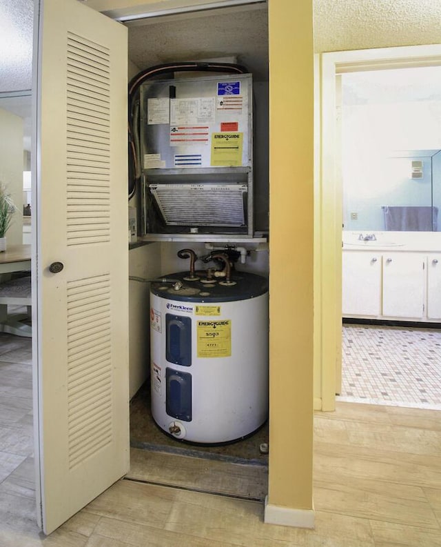 utility room featuring a sink and electric water heater